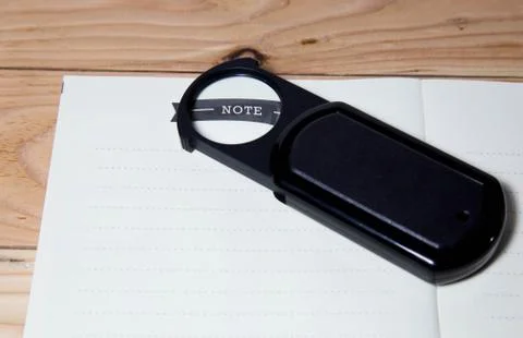 Magnifier and note book 스톡 사진