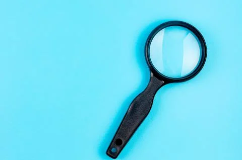 Magnifier on a blue background Stock-Fotos