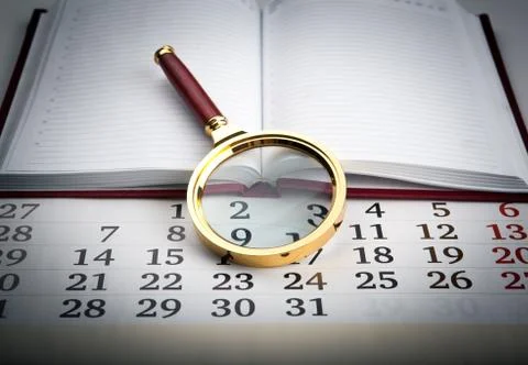 Magnifier on the diary Stock-Fotos