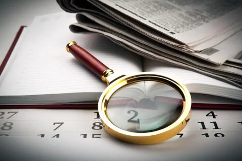 Magnifier on the diary Stock Photos