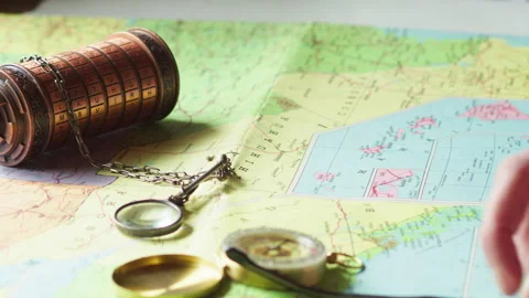 Magnifier Examining Map with Compass and Cryptex, Clue Analysis Scene Stock Footage 334718186