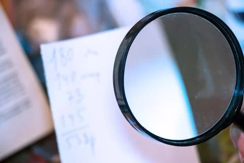 Magnifier in front of the paper Stock-Fotos