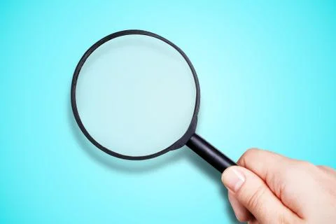 Magnifier in hand Stock Photos