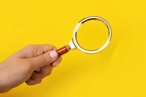 Magnifier in hand Stock Photos