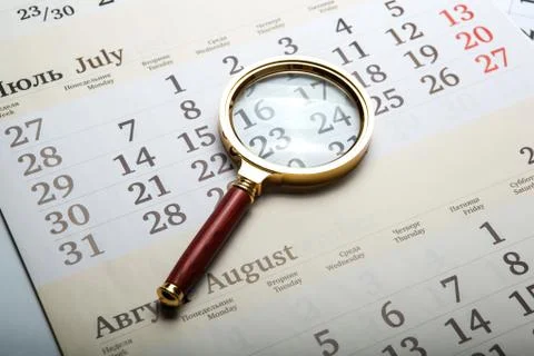 Magnifier lying on the calendar Stock Photos