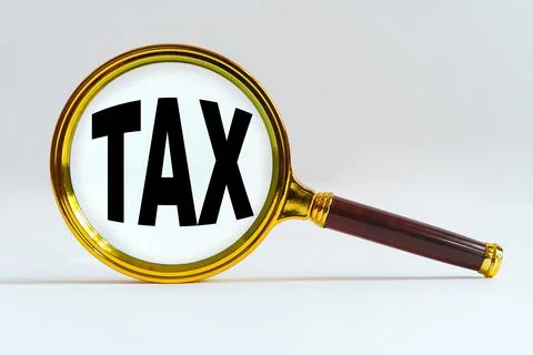 Magnifier on a white background, inside the text is written - TAX Stock Photos