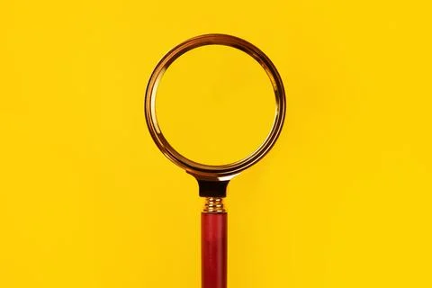 Magnifier on yellow Stock Photos