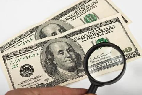 Magnifying dollars Stock Photos