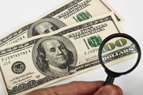 Magnifying dollars Stock Photos