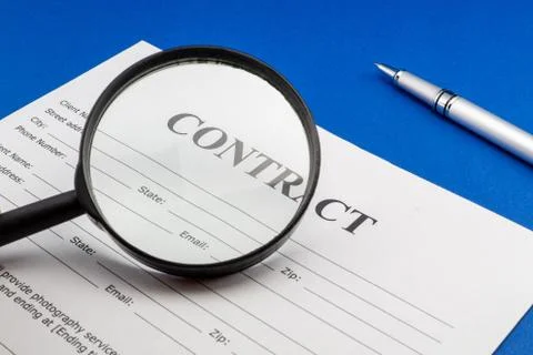 Magnifying glass and document contract close up Stock Photos