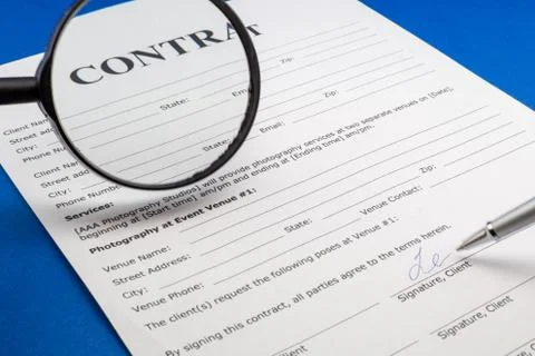 Magnifying glass and document contract close up Stock Photos