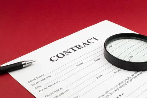Magnifying glass and document contract close up Stock Photos