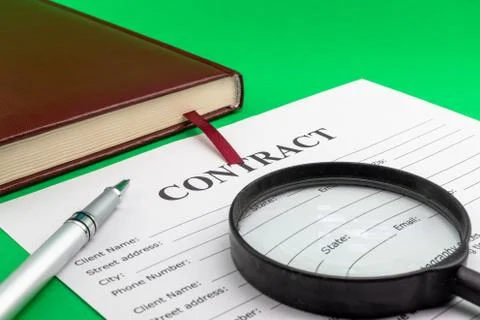 Magnifying glass and document contract close up Stock Photos