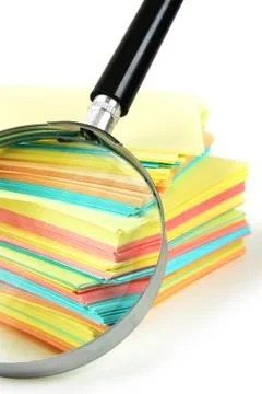 Magnifying glass and a stack of paper 写真素材