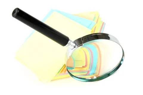 Magnifying glass and a stack of paper 스톡 사진