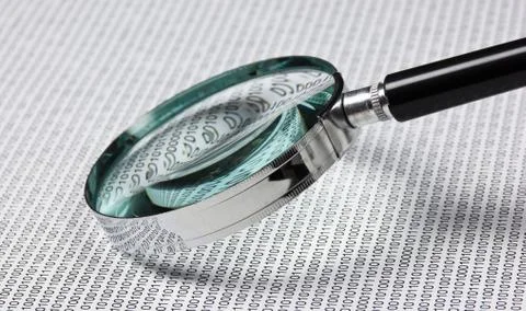 Magnifying glass on a binary code Foto stock