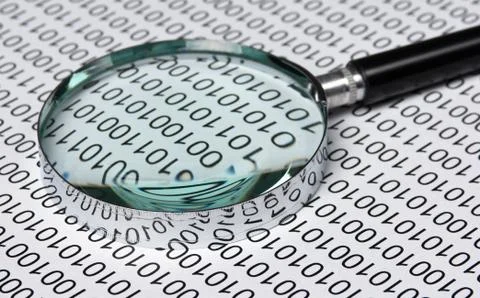 Magnifying glass on a binary code Foto stock