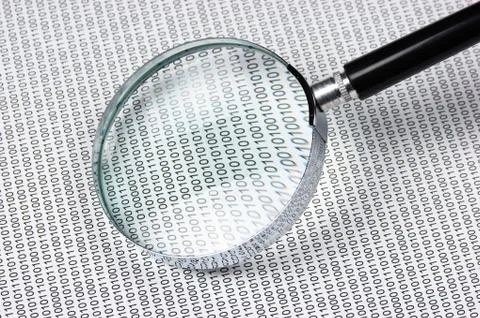 Magnifying glass on a binary code Foto stock