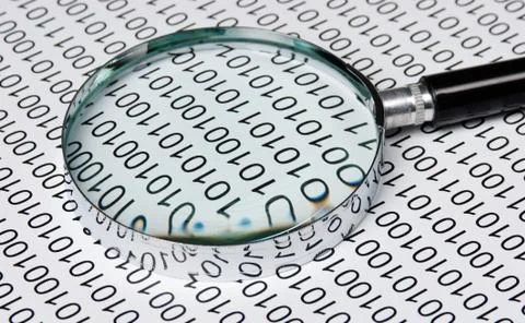 Magnifying glass on a binary code 写真素材