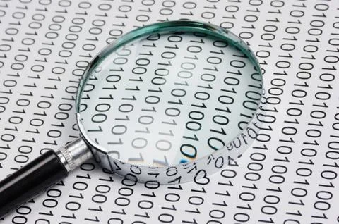 Magnifying glass on a binary code 스톡 사진