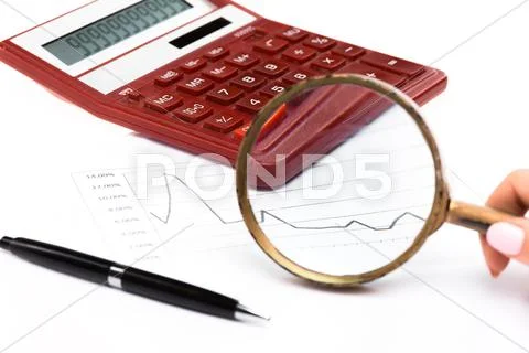 Magnifying glass with chart on paper Stock Photos