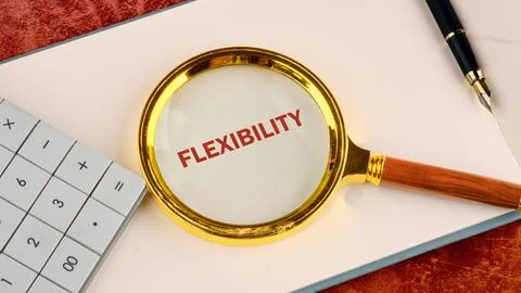 A magnifying glass emphasizes the word flexibility while a calculator and a p Stock Photos