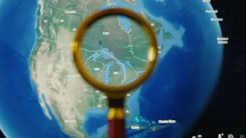 Magnifying glass exploring a world map from america to iran Stock Footage 339806274