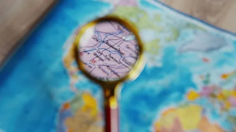 Magnifying glass exploring a world map Video stock 339806518