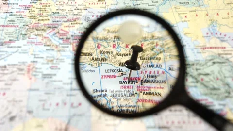 Magnifying glass finding Beirut on a printed paper map Stock Footage 341904284