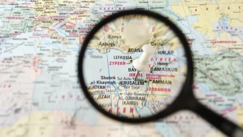 Magnifying glass finding Jerusalem on a printed paper map Stock Footage 341904278