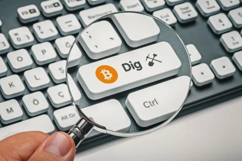 Magnifying glass in hand focused on computer key with bitcoin symbol and dig Stock Illustration