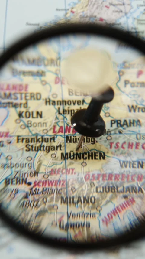 Magnifying glass highlights location marked on printed map Stock Footage 342435514