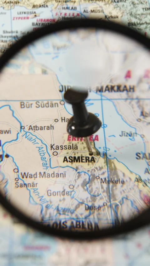 Magnifying glass locating Asmara on a printed map Stock Footage 341904283