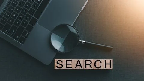 A magnifying glass is placed on a notebook computer Stock-Fotos