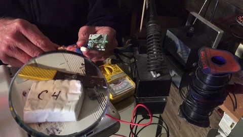 Magnifying glass, Plastic explosive loaded into laptop computer Stock-Footage 74274282