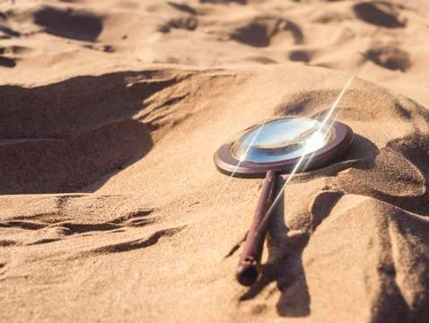 Magnifying glass reflection on the send Stock Photos
