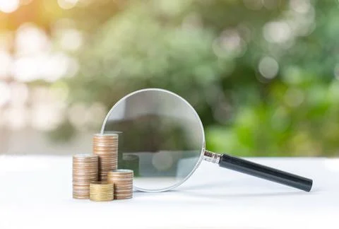 Magnifying glass on the stack of coins. Foto stock