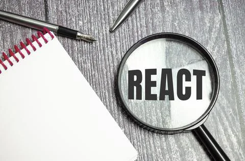 Magnifying glass with the text react javascript library Stock-Fotos