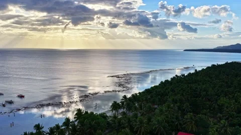 Mahaba Beach, Philippines, with rays of light illuminating ocean and coastline Stock Footage 334691719