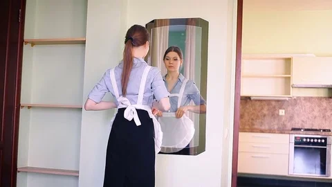 The maid cleans the mirror Stockbeeldmateriaal 82160857