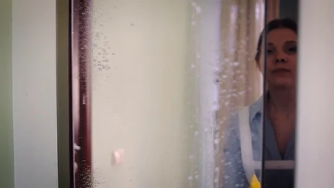 The maid cleans the mirror Video stock 82161612