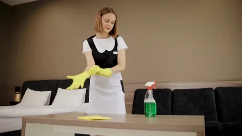 Maid Preparing to Clean Room With Gloves and Cleaning Supplies Stock Footage 300996956