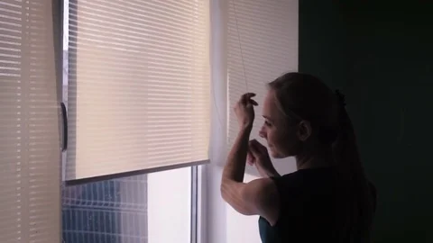 The maid raises the curtains on the window Stock Footage 83300682