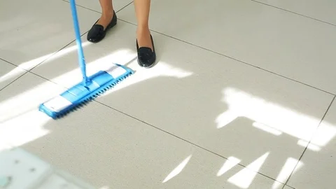 The maid washing the floor. Stockbeeldmateriaal 82069042