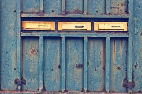 Mail boxes on rusty door Stock Photos