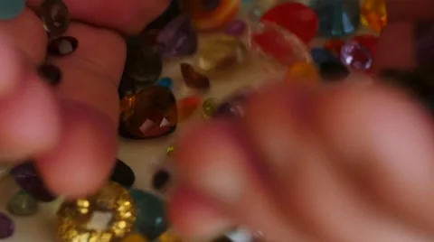 Mail hand pour out precious gemstones slow motion 1 Stock Footage 45480583
