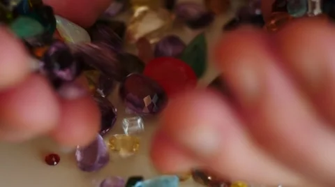 Mail hand pour out precious gemstones slow motion 2 Stock Footage 45480598