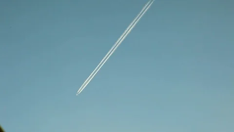 A mail liner or a passenger plane flies across a blue sky Stock Footage 120426404