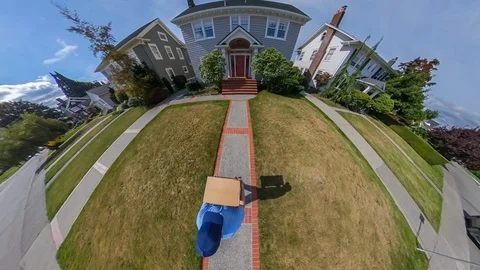 Mail man delivers a package to a colonial style home Stock Footage 116361613