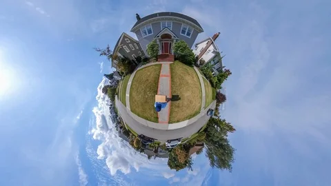 Mail man delivers a package to a colonial style home Stock Footage 116390337